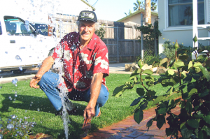 a Grand Prairie Sprinkler Repair tech repairs an irrigation line